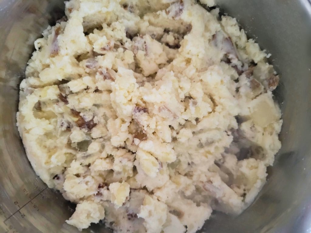 mashed potatoes in a stainless steel pot