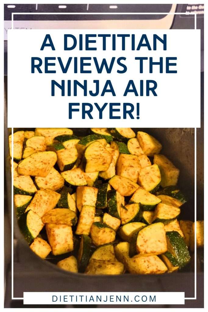 Text: A dietitian reviews the ninja air fryer! overlaid of an image of roasted zucchini in an air fryer basket