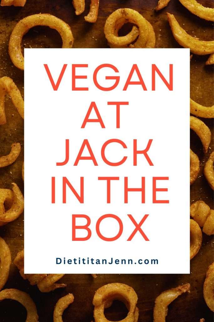 curly fries in single layer on brown sheet pan text overlay reads "vegan at jack in the box"