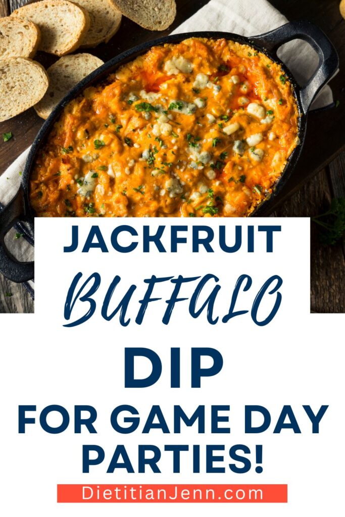 jackfruit buffalo dip in an oval cast iron dish next to bread slices on a dark wooden surface. Text below reads, "Jackfruit Buffalo Dip for Game Day Parties!"