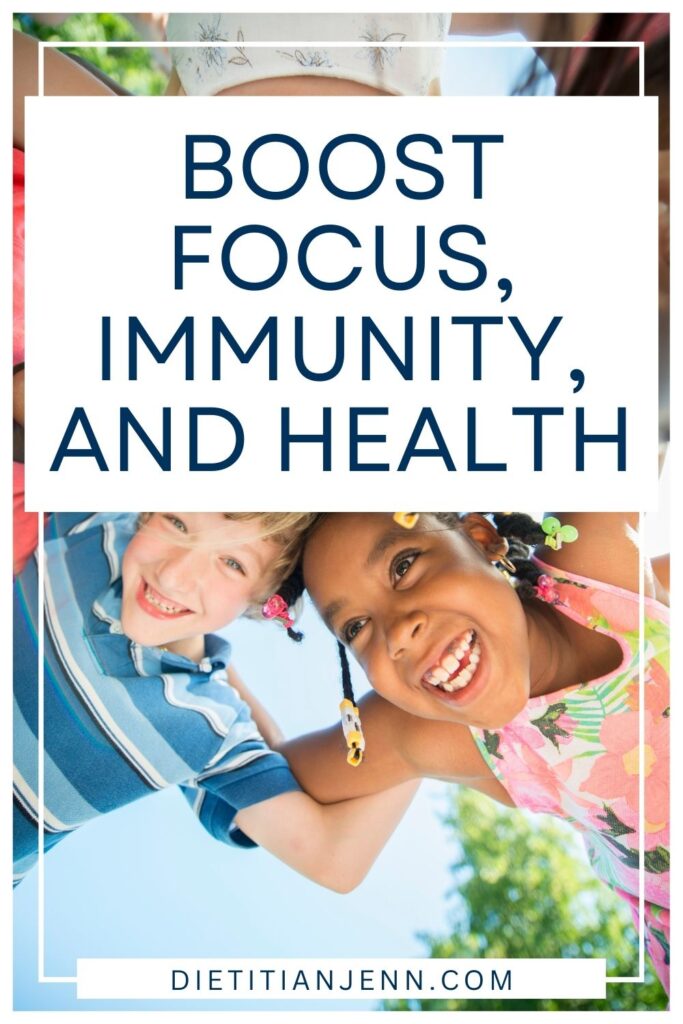 5 kids (only a boy and girl clearly visible) interlocking arms and looking down at the camera while playing outside. Overlaid text reads, "Boost Focus, Immunity, & Health"
