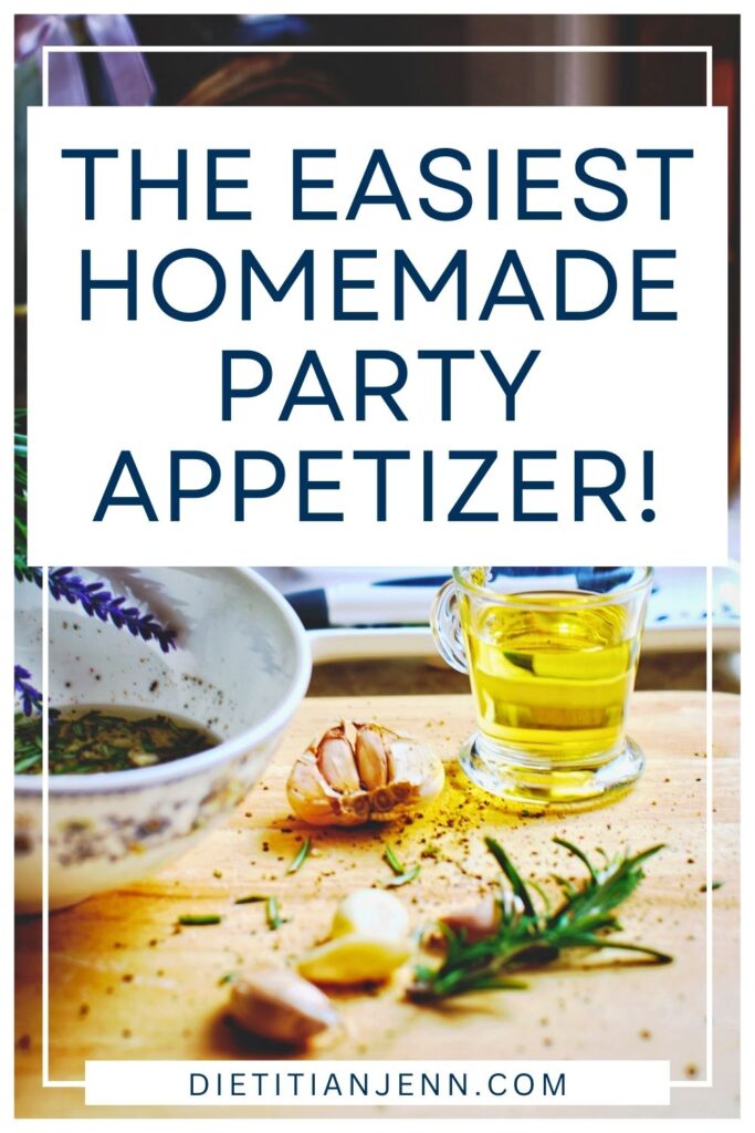 olive oil and fresh herbs in a blue and white bowl. scattered around are fresh rosemary and garlic, dried herbs, and olive oil in a glass jar. overlaid text reads, "The Easiest Homemade Party Appetizer!"