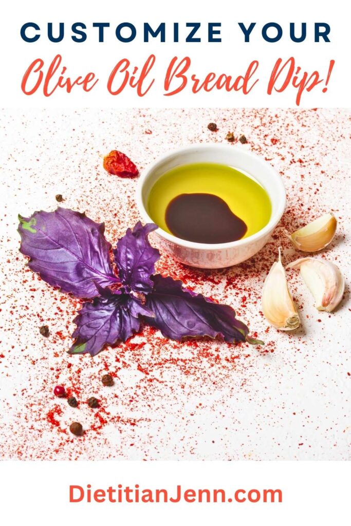 olive oil and balsamic vinegar in a small white bowl, there is a red dried spice scattered on a white surface around the bowl, along with fresh garlic cloves and purple basil. text above reads, "Customize Your Olive Oil Bread Dip!"