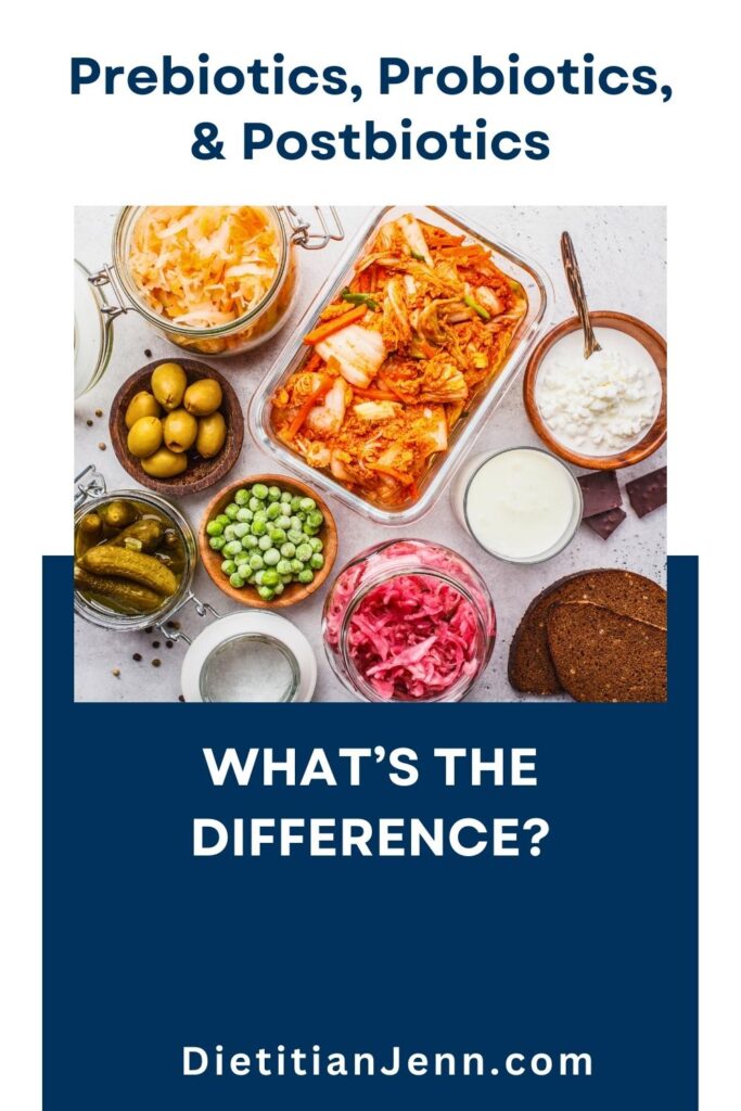a variety of fermented food in wooden bowls and clear glass containers on a grey surface. text above and below reads, "prebiotics, probiotics, and postbiotics. What's the Difference?"