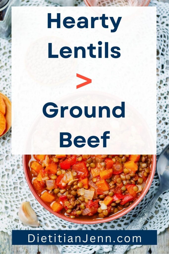 Lentil stew in a red bowl on a white doily, on a grey wooden surface. overlaid text reads, "Hearty Lentils > Ground Beef"
