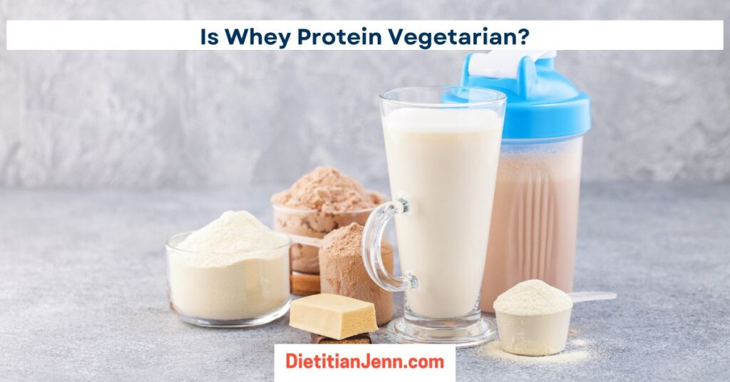 vanilla and chocolate whey protein powders in scoops with marbled grey, surface and background. There is also a glass of milk and a shaker bottle of prepared protein shake. text above reads, "Is Whey Protein Vegetarian?"