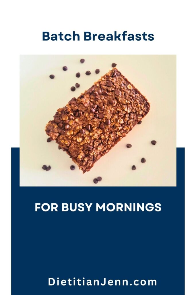 a square of baked oatmeal on a white surface. Text reads, "Batch Breakfasts For Busy Mornings"