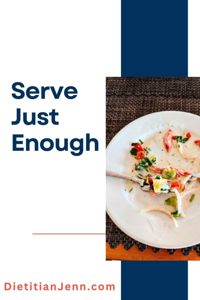 a white plate on a black woven place mat that has very little of a pasta dish remaining. text to the left reads, "Serve Just Enough"