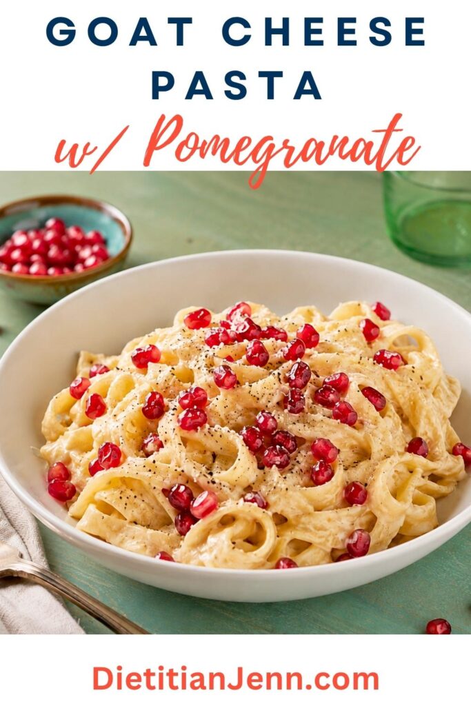 goat cheese pasta with pomegranate in a white bowl on a blue tabletop. text reads, "Goat Cheese Pasta w/ Pomegranate"